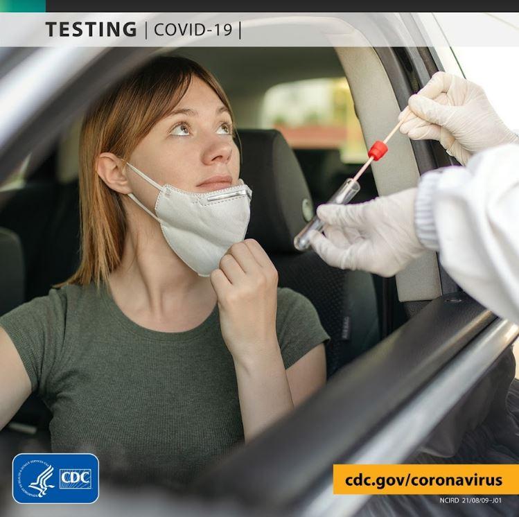 Woman removing mask from her face preparing to receive a PCR COVID-19 test