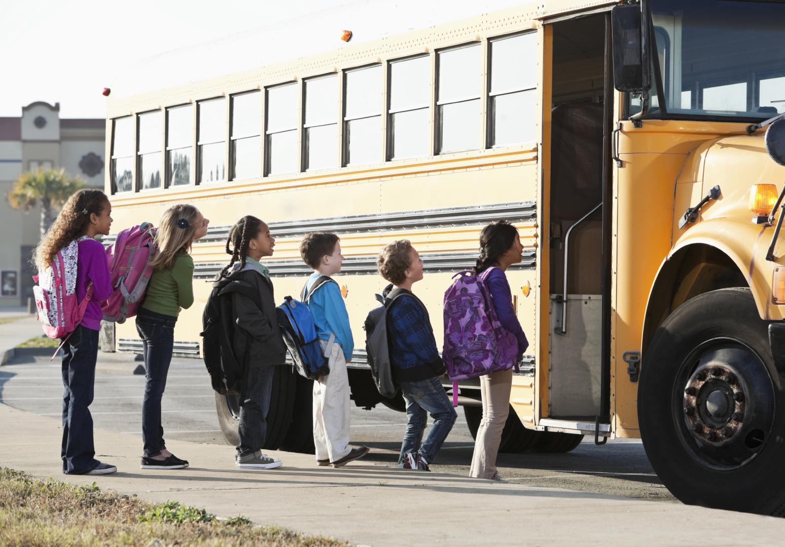 Children getting on school bus