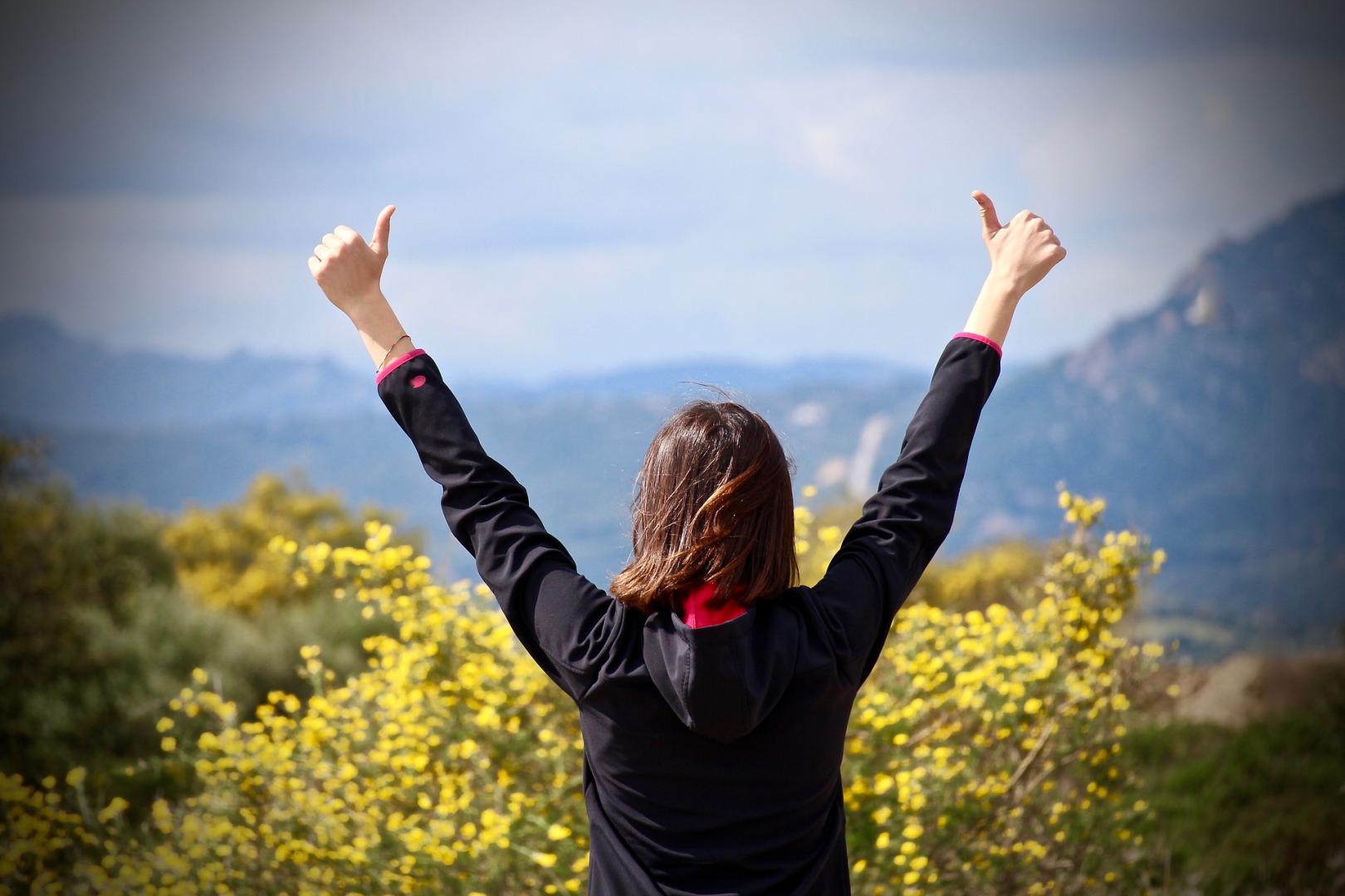 Woman holding two thumbs up