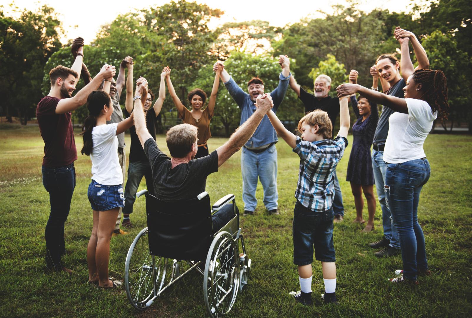 A diverse group holding hands