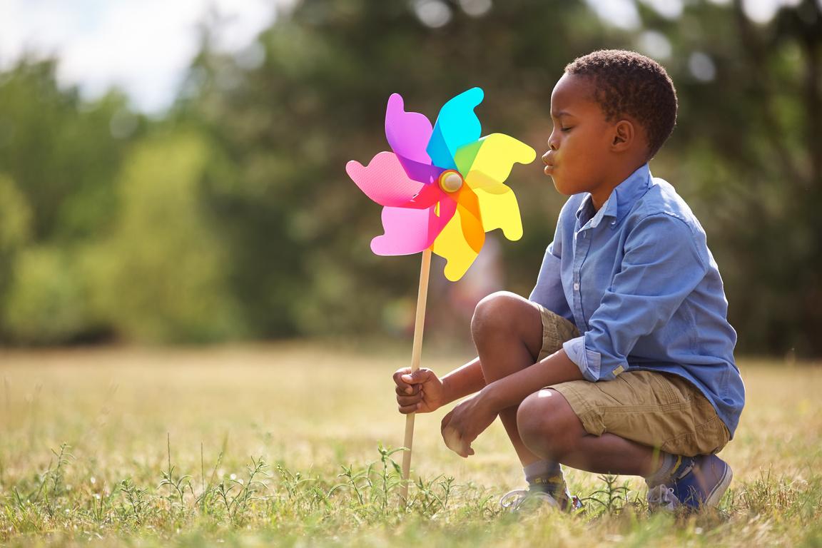 Child with rainbow pinwheel