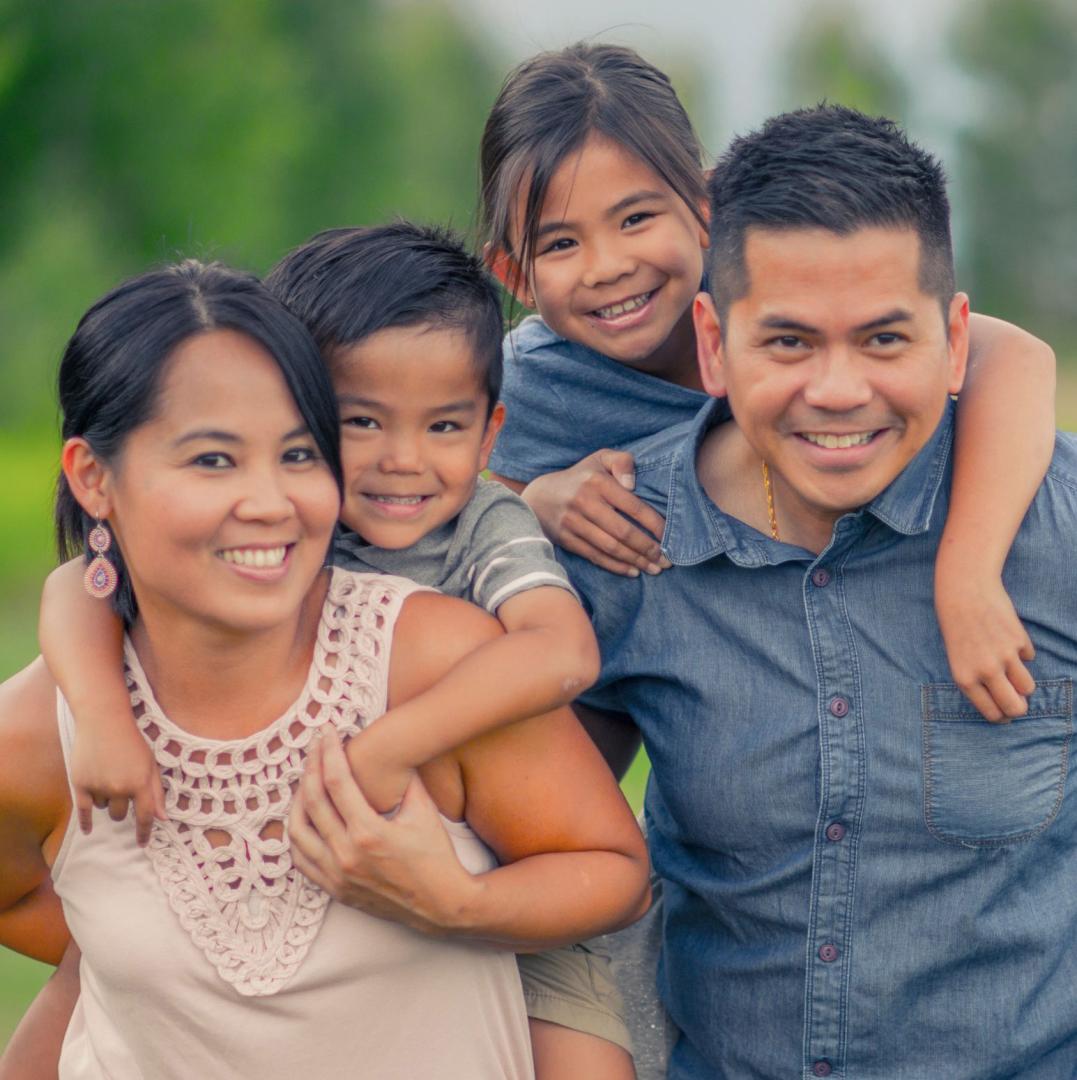 A family of four smiling