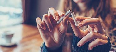a cigarette being broken in half 