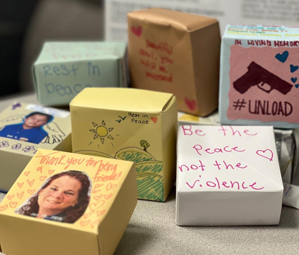 A bunch of Soul Boxes with photos of anti gun violence or people's faces on them