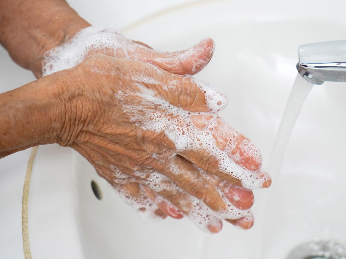 A person washing their hands with soap and water