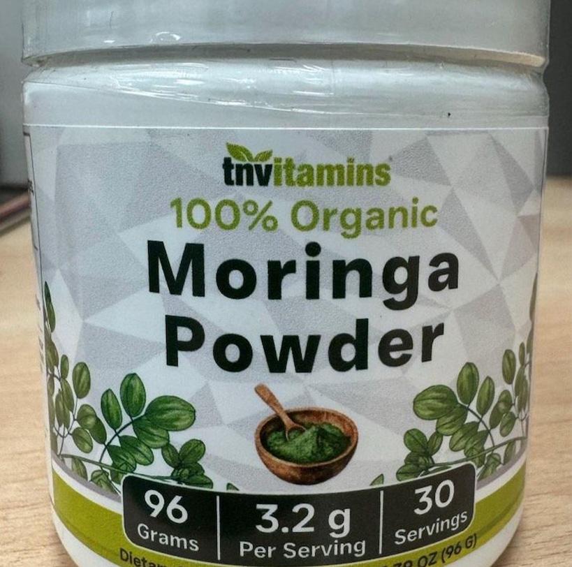 A container of tnvitamins 100% organic moringa powder